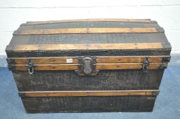 A VINTAGE DOMED TOP TRAVELLING TRUNK, with crocodile effect and wooden banding, labelled to inner