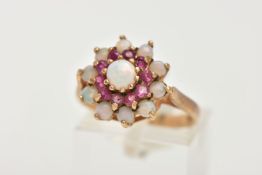 A 9CT GOLD RUBY AND OPAL CLUSTER RING, tiered cluster set with a central circular opal cabochon to a