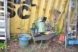 THREE GLAZED PLANT POTS AND A WHEELBARROW containing a quantity of garden tools