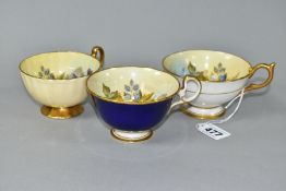 THREE AYNSLEY CABBAGE ROSE TEA CUPS DECORATED BY J.A. BAILEY, comprising pattern no. 1028 with solid