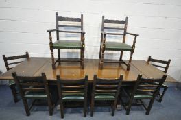 A REPRODUCTION OAK DRAW LEAF REFECTORY DINING TABLE, on twin acorn supports united by a floor