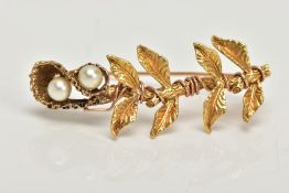 A YELLOW METAL PEARL BROOCH, a floral and foliage styled brooch with a twisted wire design, set with