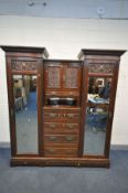 AN EDWARDIAN MAHOGANY COMPACTUM WARDROBE, with detailed foliate panels, two outer cupboard doors