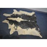 A LARGE BLACK AND WHITE COW HIDE RUG, length 212cm x width 189cm