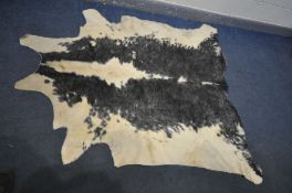 A LARGE BLACK AND WHITE COW HIDE RUG, length 212cm x width 189cm