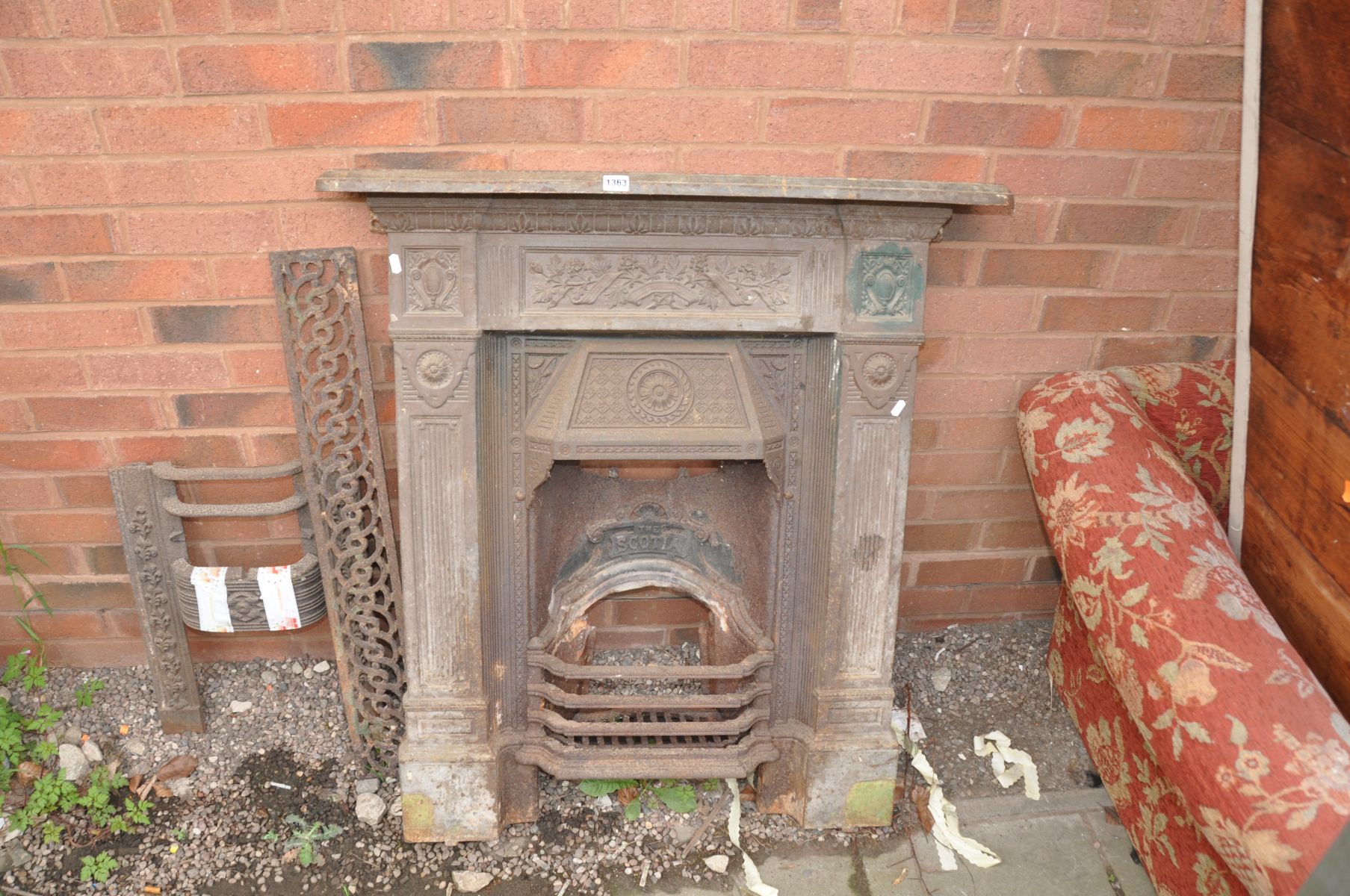 A CAST IRON FIRE SURROUND, with foliate and columned detailing, 'The Scotia' to the centre, along