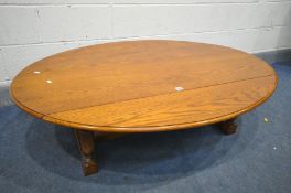 AN OAK DROP LEAF OVAL COFFEE TABLE, on turned legs and block feet, united by stretchers, length