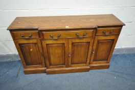 A REPRODUCTION OAK BREAKFRONT SIDEBOARD, with three various drawers above four cupboard doors,