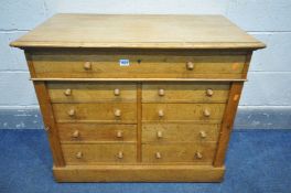 AN EARLY 20TH CENTURY OAK LOW WELLINGTON CHEST, made up of one long drawer over two banks of four