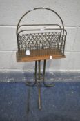 A VICTORIAN BRASS AND OAK MAGAZINE RACK, with twin division, on brass legs, stamped 'Hall BM' to