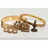 TWO GOLD PLATED HINGED BANGLES, TWO FOB SEALS AND A PENDANT, to include a floral engraved hinged