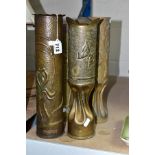 TRENCH ART, four WWI brass shell cases embossed with foliate designs, one titled 'CHAMPAGNE' towards