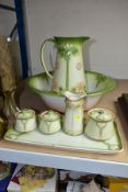 A GRIMWADES POTTERY ART NOUVEAU STYLE FIVE PIECE DRESSING TABLE SET AND A SIMILAR WASH JUG AND BOWL,