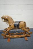 A 20TH CENTURY IAN ARMSTRONG LAMINATED ROCKING HORSE, on a trestle base, bearing brass label width