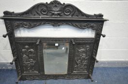 AN 19TH CENTURY CARVED OAK HALL MIRROR, with masks, and two panels flanking a bevelled mirror, width