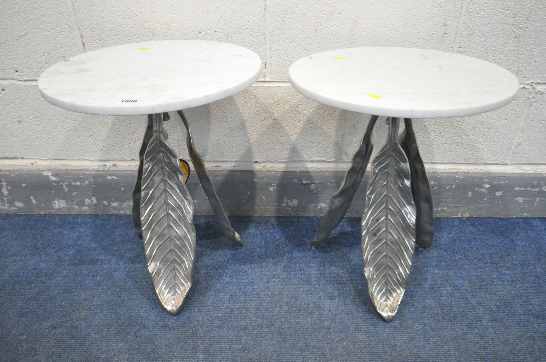 A PAIR OF WHITE CIRCULAR MARBLE TOP SIDE TABLES, on a three silvered leaves support, diameter 41cm x