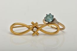 A YELLOW METAL DIAMOND SET BROOCH AND A RING, the brooch of an open work infinity design set with