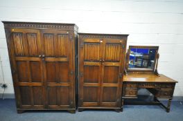 A REPRODUCTION OAK BEDROOM SUITE, comprising a two sized two door linenfold wardrobes, largest