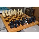 AN ISLE OF LEWIS STYLE CHESS SET, with wooden board 49.5cm square, cast resin cream and black pieces