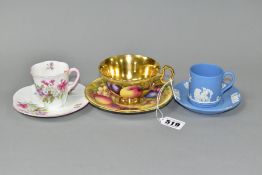 AN AYNSLEY ORCHARD GOLD TEA CUP AND SAUCER TOGETHER WITH TWO COFFEE CANS AND SAUCERS, the Orchard