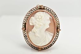 A YELLOW METAL CAMEO BROOCH, of an oval form, depicting a lady in profile with a flower in her hair,
