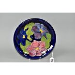 A MOORCROFT POTERY CLEMATIS PATTERN SHALLOW DISH, paper Moorcroft label 'Potters to the Late Queen