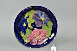 A MOORCROFT POTERY CLEMATIS PATTERN SHALLOW DISH, paper Moorcroft label 'Potters to the Late Queen