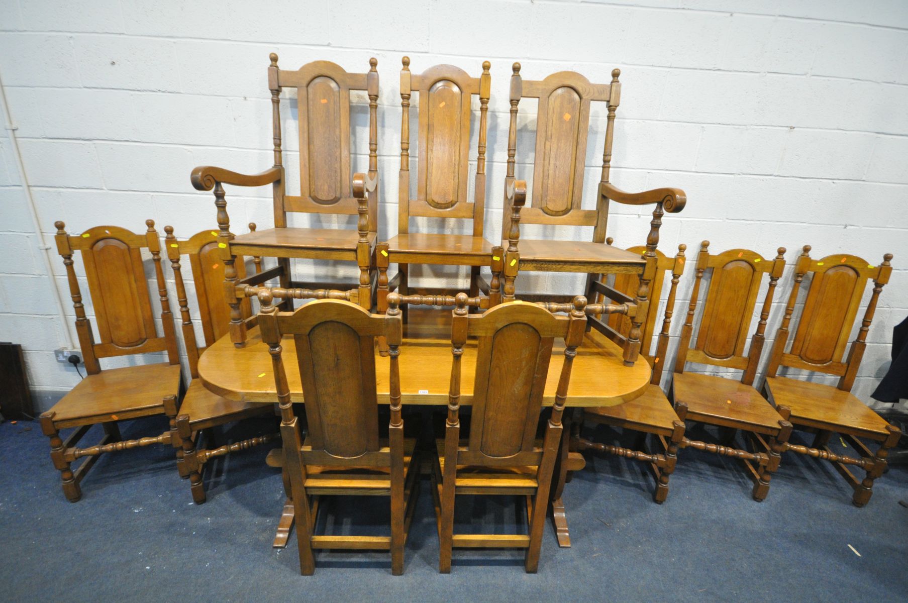 A SET OF TEN LIGHT SOLID OAK HIGH BACK DINING CHAIRS, with fielded panel backs, turned stretchers,