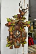 A LATE 20TH CENTURY GERMAN CUCKOO CLOCK, with pendulum and weights, movement in need of restoration,