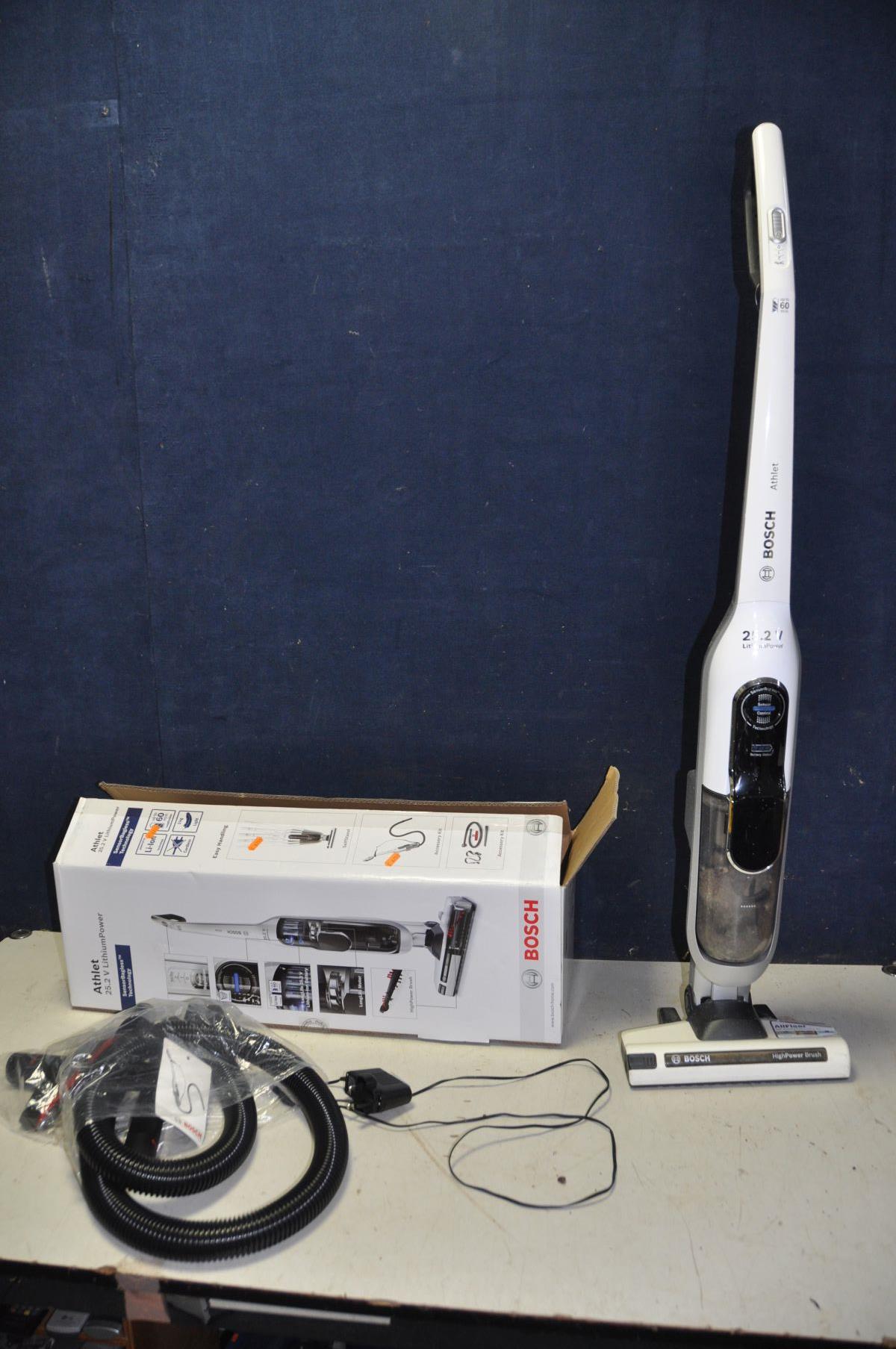 A BOSCH ATHLET 25.2V CORDLES UPRIGHT VACUUM CLEANER with original box, attachments and charger (