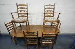 A REPRODUCTION OAK EXTENDING DINING TABLE, with one fold out leaf, open length 199cm x closed length