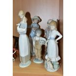 FIVE NAO PORCELAIN FIGURINES, comprising a girl with a hoop, two children with puppies, a boy with a