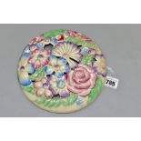 A CLARICE CLIFF WILKINSON LTD CIRCULAR BOUQUET WALL PLAQUE, relief moulded with pastel colour