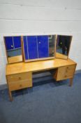 A STAG OAK DRESSING TABLE, with a triple mirror and five drawers, width 150cm x depth 47cm x