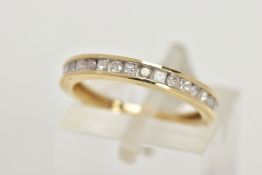 A 9CT GOLD DIAMOND HALF ETERNITY RING, designed with a row of alternating round brilliant cut and
