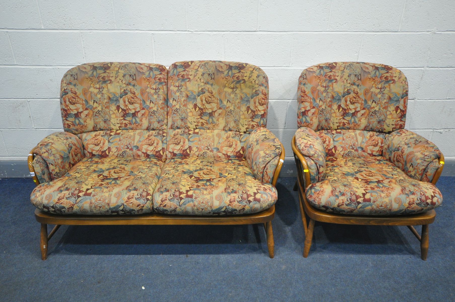 AN ERCOL ELM WINDSOR JUBILEE TWO PIECE LOUNGE SUITE, comprising of a two seater sofa and an arm