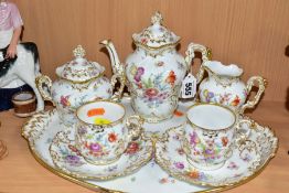 A GERMAN PORCELAIN TEA FOR TWO SET, painted with flowers, moulded with gilt highlights, comprising