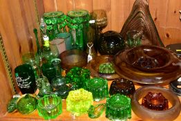 A GROUP OF GREEN, BROWN AND URANIUM GLASSWARES, to include pressed glass furniture rests/piano