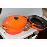 THREE PIECES OF LE CREUSET AND SIMILAR CAST IRON COOKWARES, comprising a Le Creuset oval casserole