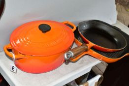 THREE PIECES OF LE CREUSET AND SIMILAR CAST IRON COOKWARES, comprising a Le Creuset oval casserole