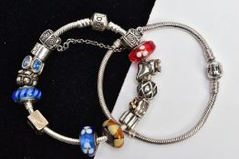 TWO PANDORA BRACELETS AND CHARMS, two white metal snake chain bracelets, fitted with folding