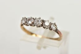 A YELLOW METAL FIVE STONE DIAMOND RING, set with four old cut diamonds and one round brilliant cut