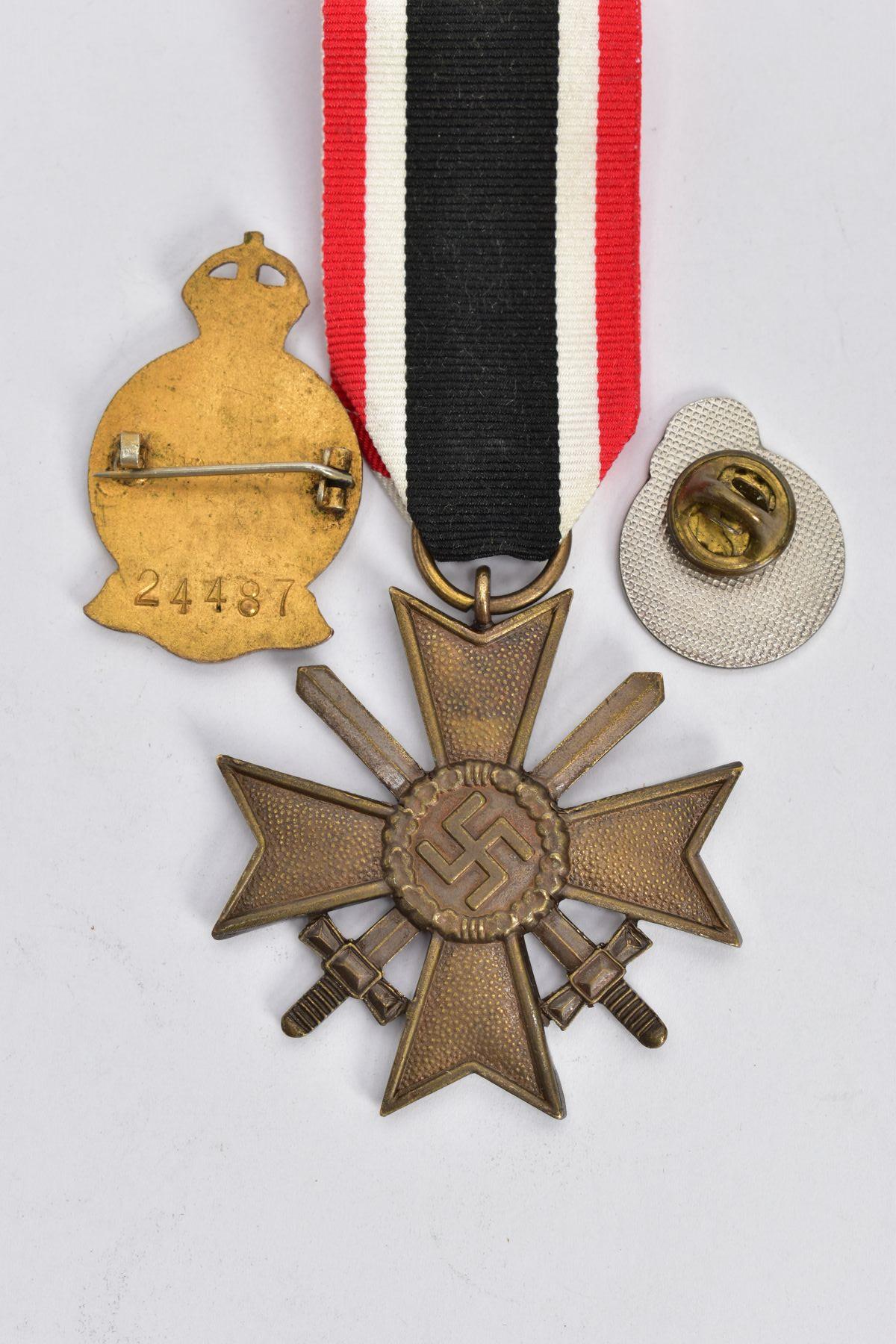 A GERMAN WORLD WAR TWO WAR MERIT CROSS WITH SWORDS, in bronze, the ring suspender is marked with the - Image 3 of 3