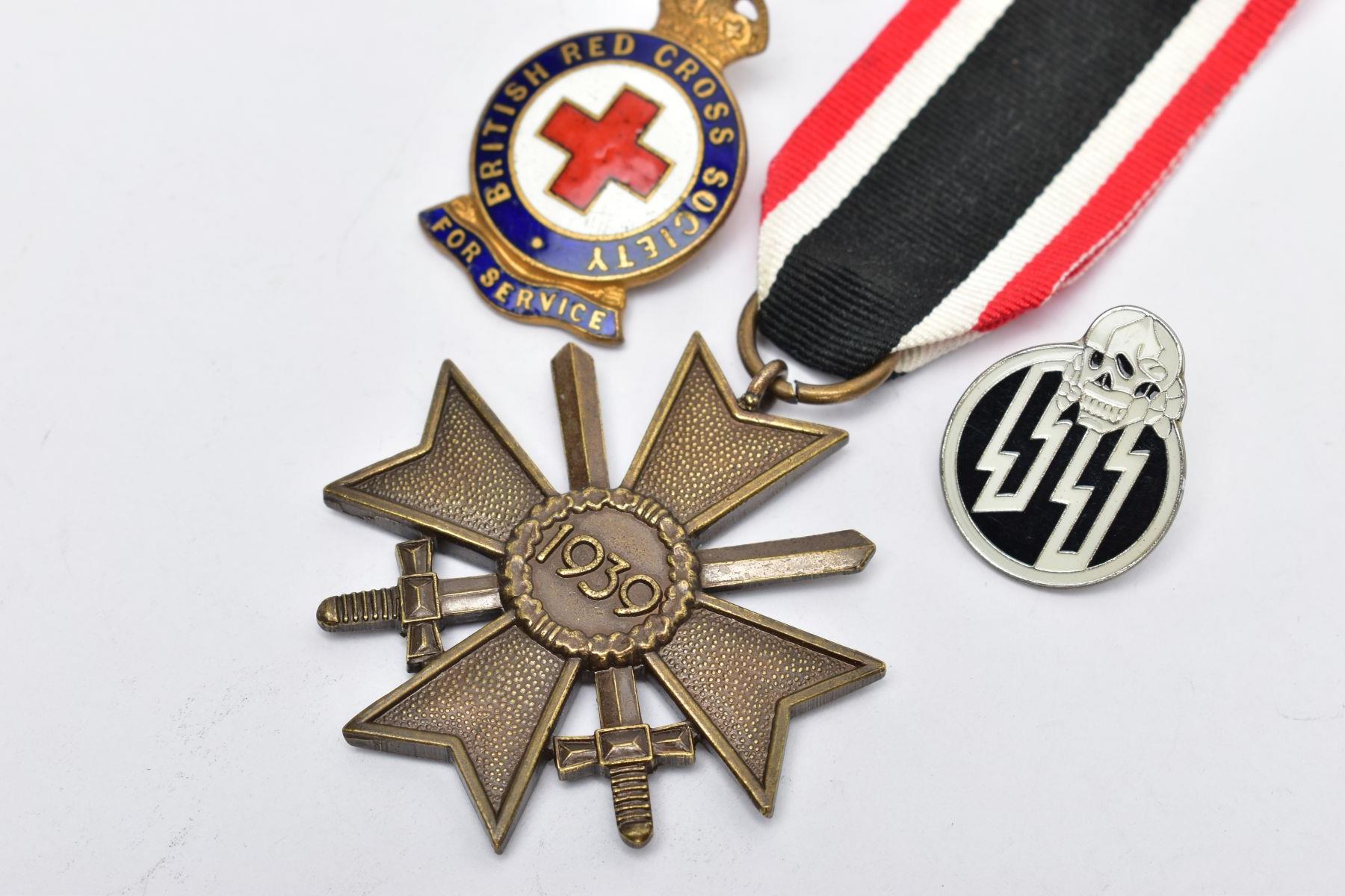 A GERMAN WORLD WAR TWO WAR MERIT CROSS WITH SWORDS, in bronze, the ring suspender is marked with the - Image 2 of 3