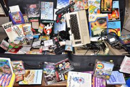 A COMMODORE 64 COMPUTER, OVER ONE HUNDRED BOXED GAMES AND ACCESSORIIES, spread across two cases, one