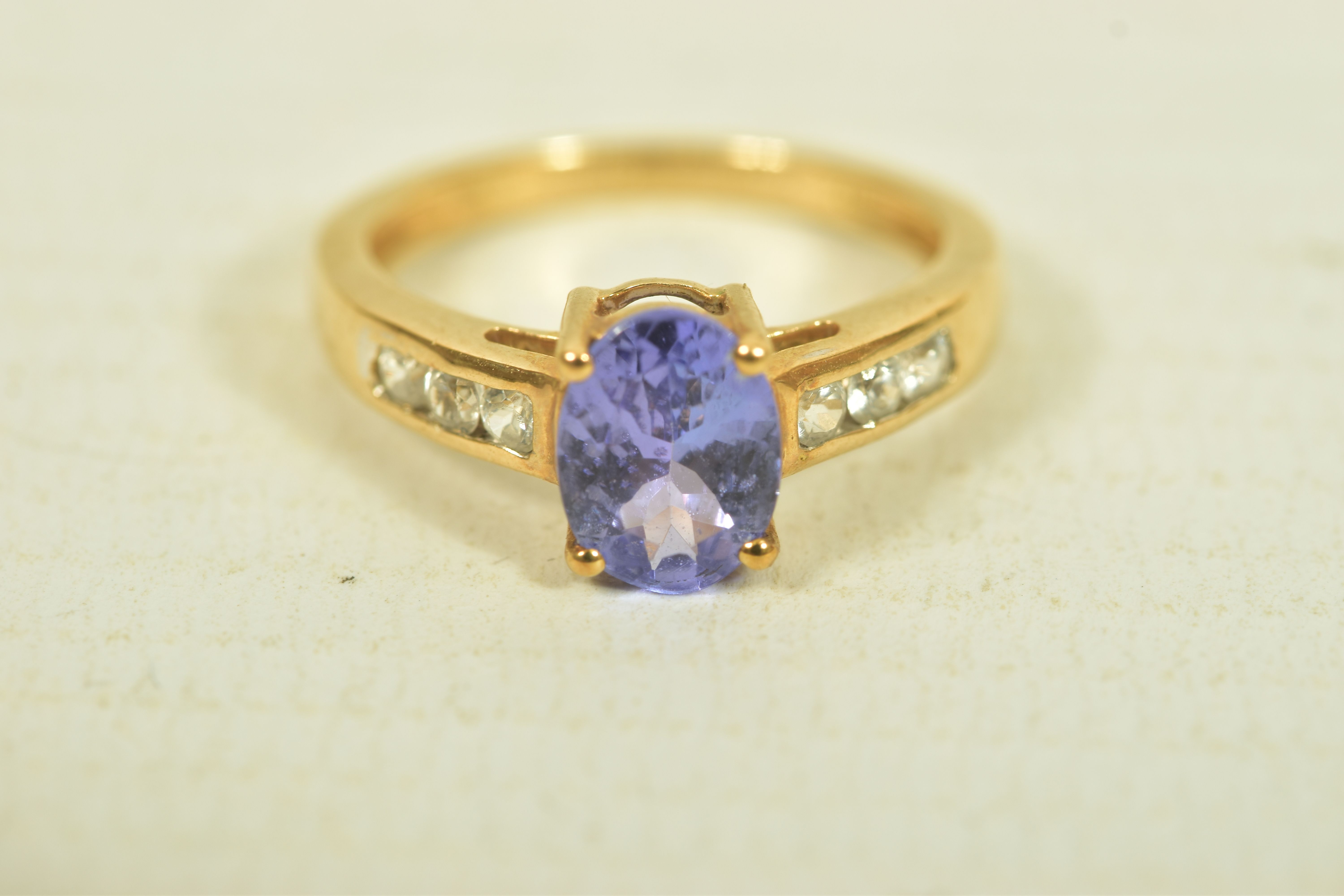 A 9CT GOLD TANZANITE AND COLOURLESS GEM DRESS RING, the oval tanzanite, to the circular colourless - Image 6 of 6