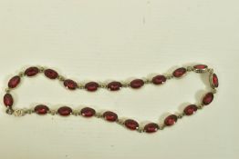 A WHITE METAL VARI COLOUR PASTE NECKLACE, comprising of twenty one oval shape red interspaced with
