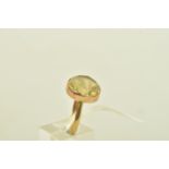 A YELLOW METAL CITRINE RING, the circular shape citrine is collet set to the unmarked yellow metal