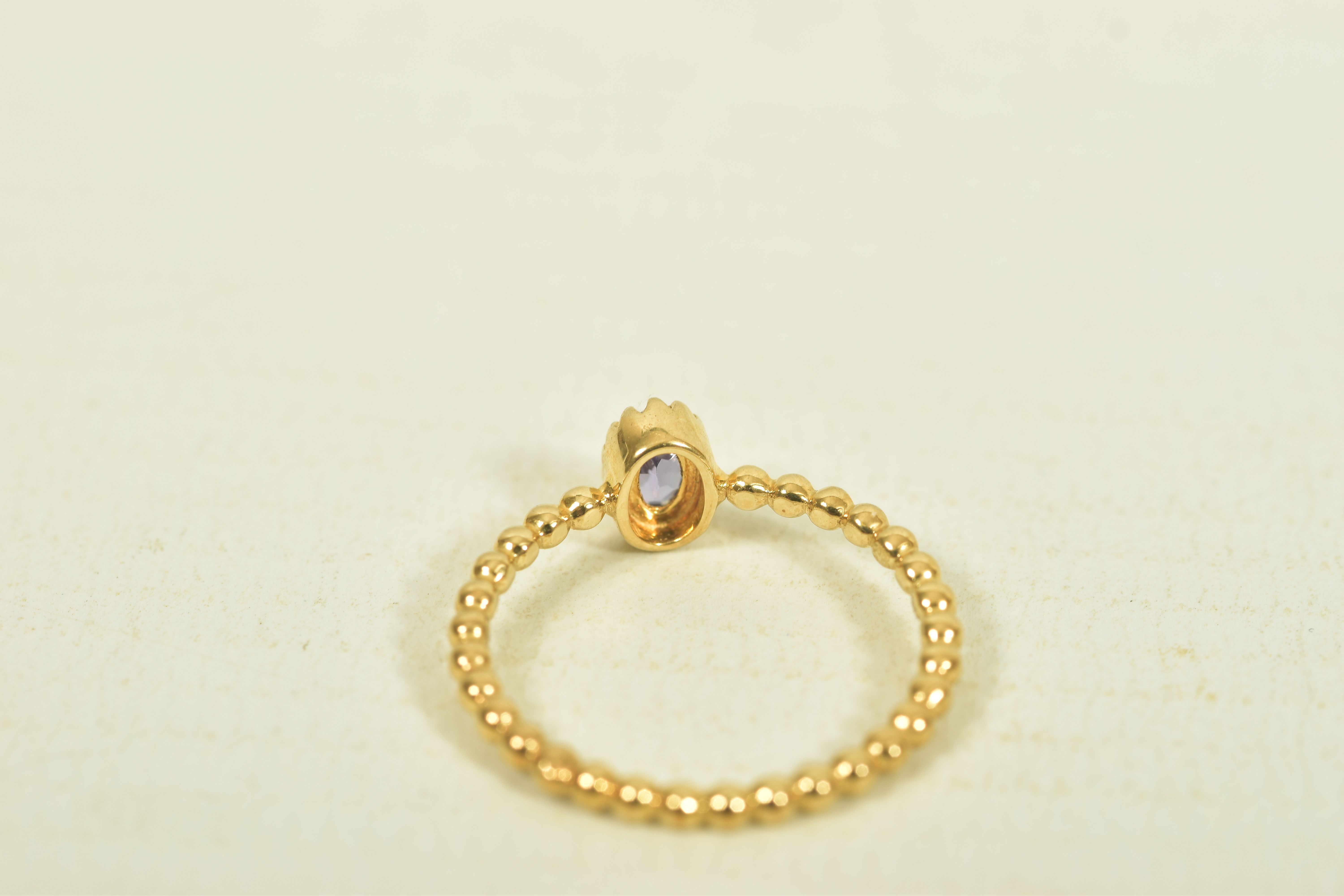 A 9CT GOLD TANZANITE SINGLE STONE RING, the oval shape tanzanite, to the bead detail band, - Image 5 of 6