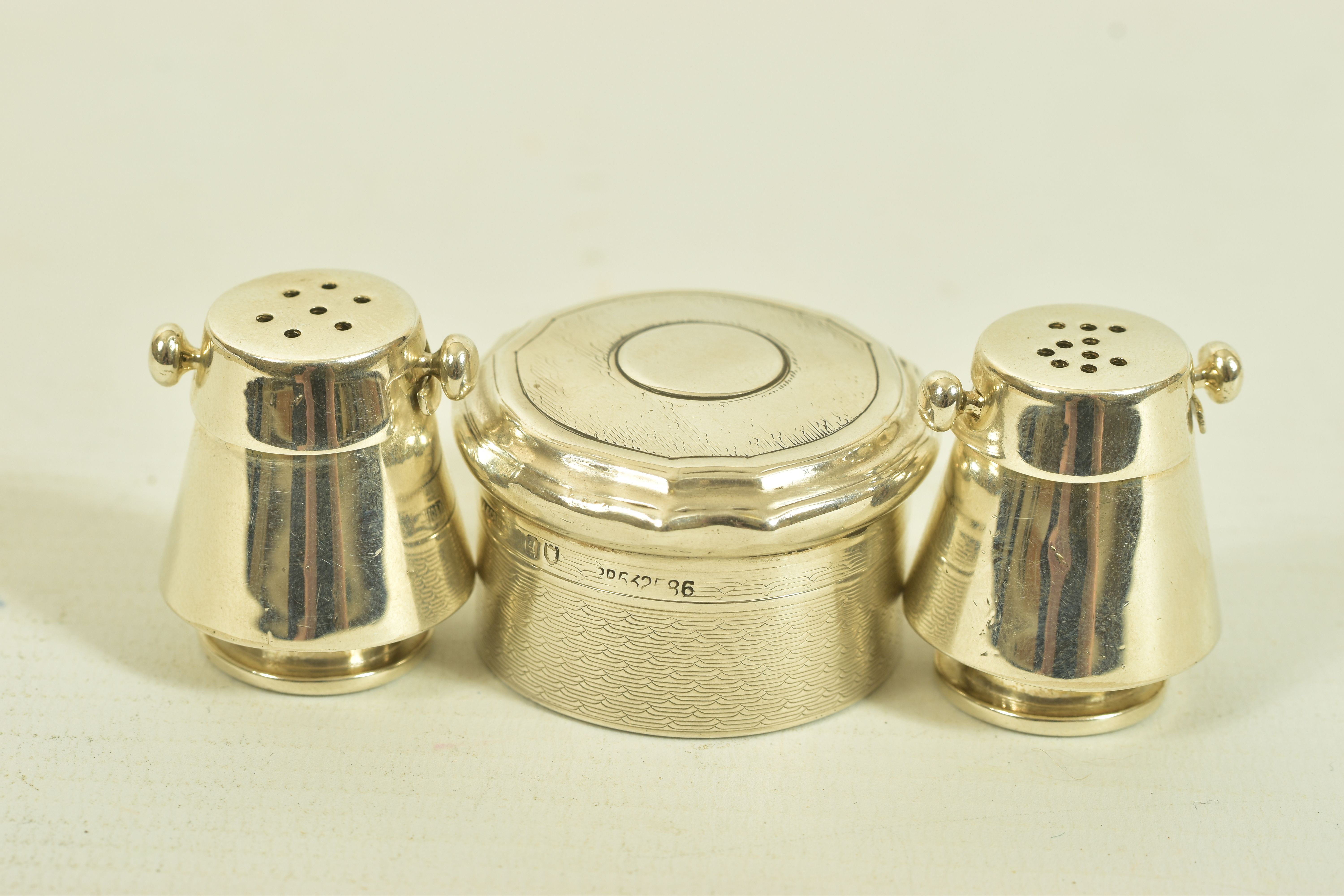 A PAIR OF NOVELTY SALT AND PEPPER POTS, TOGETHER WITH AN EARLY 20TH CENTURY SILVER ASPREY & CO. PILL
